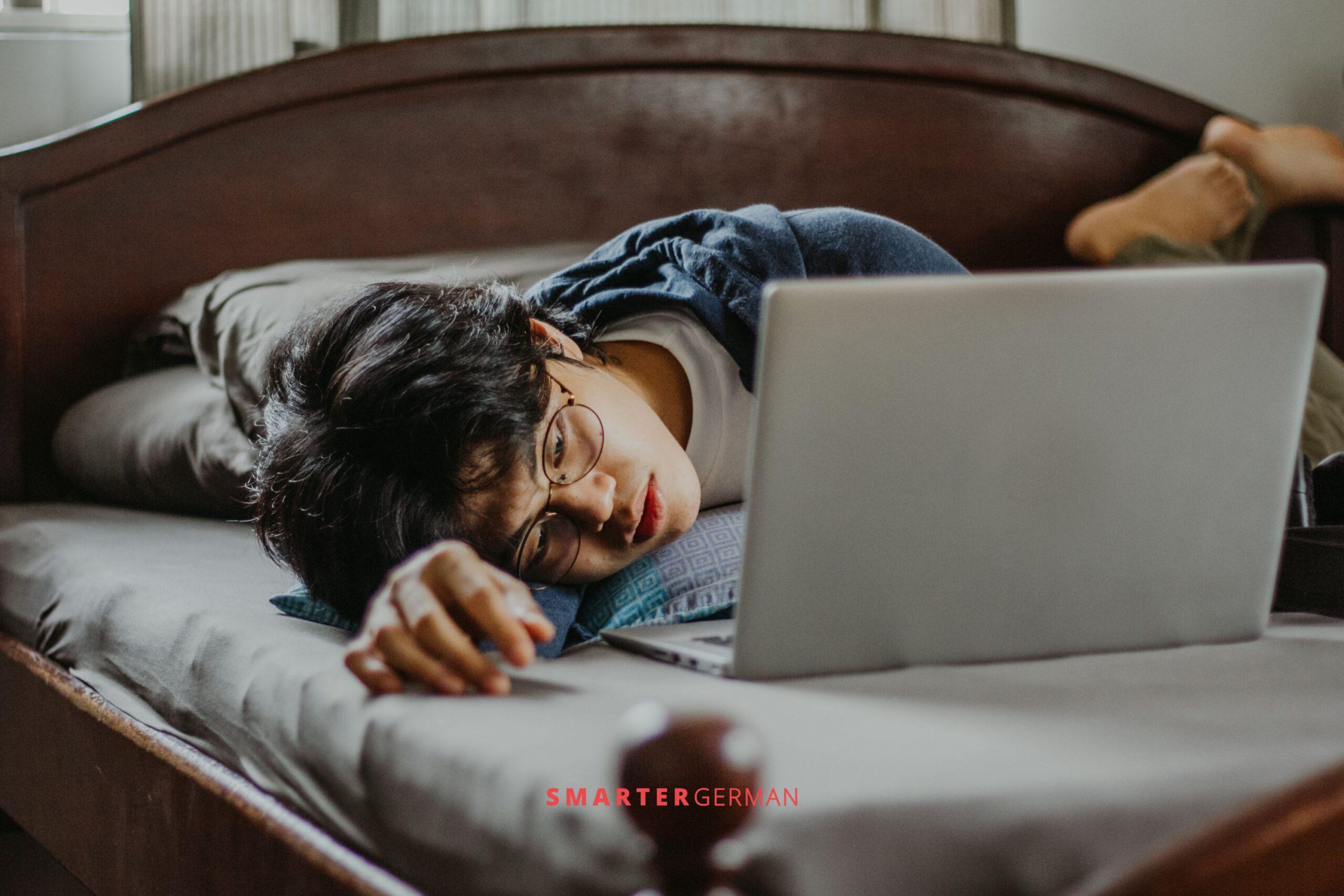 Man in his bed in front of a laptop